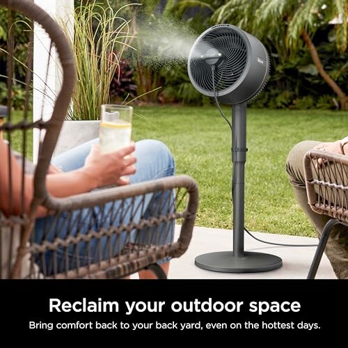 People enjoying outdoor space with a misting fan.